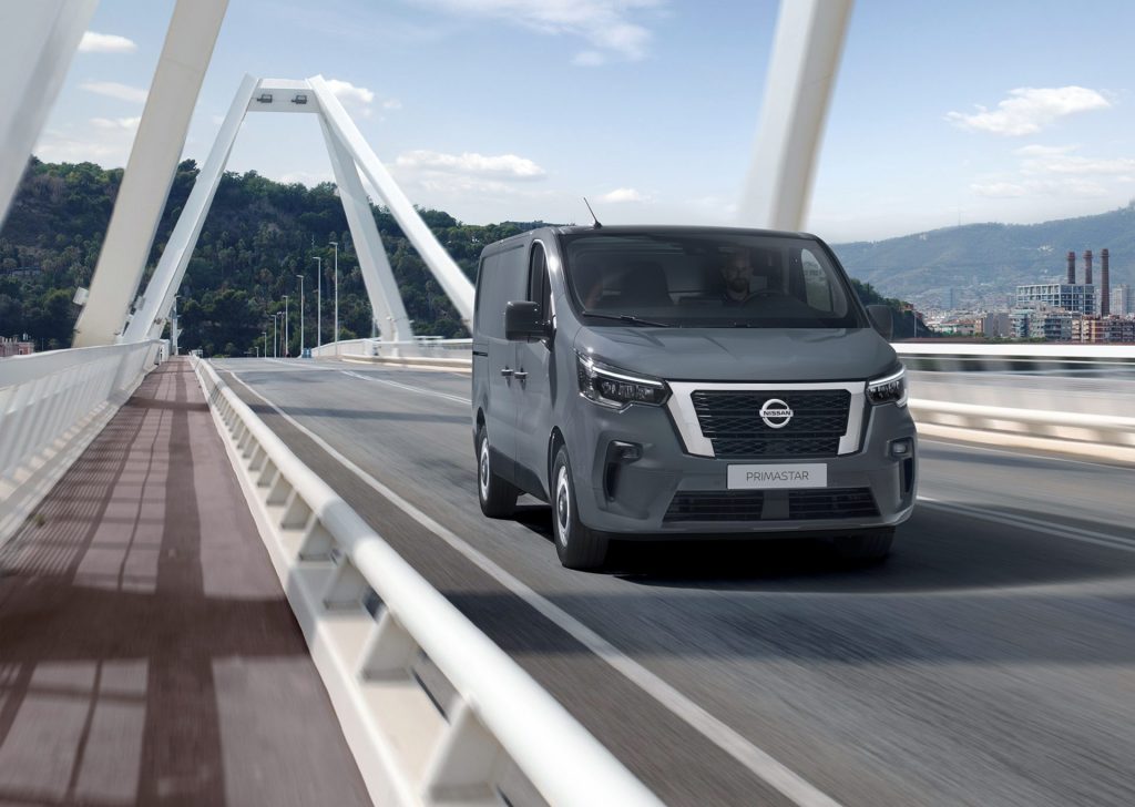 Grå Nissan Primastar kör på bro