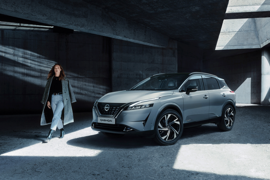 Nissan Qashqai e-POWER med affärskvinna som går till vänster om bilen